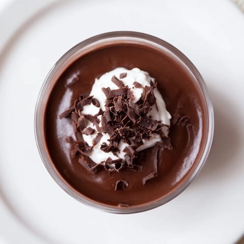 A glistening glass of chilled chocolate pudding, ready to be enjoyed as dessert tonight.