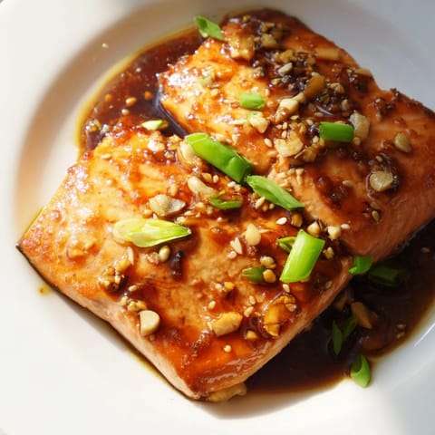 Close-up of flaky Honey Garlic Salmon with a sweet, savory sauce, perfect dinner idea.