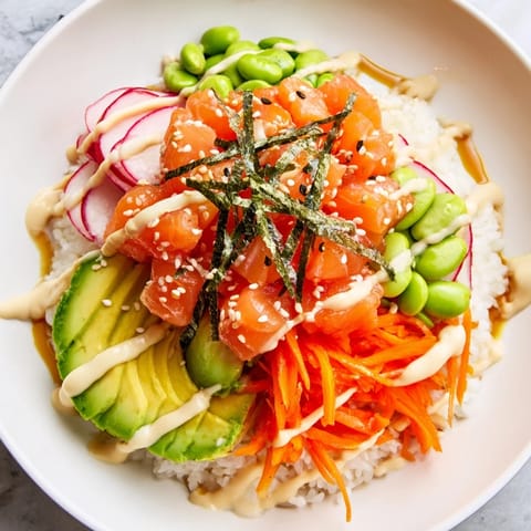 A visually appealing poke bowl featuring marinated fish, rice, and delicious toppings; a great lunch!