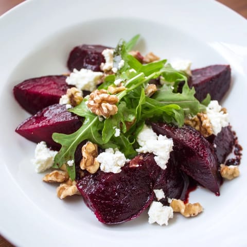 Warm roasted beet goat cheese salad topped with crunchy toasted walnuts and a bright balsamic vinaigrette drizzle.