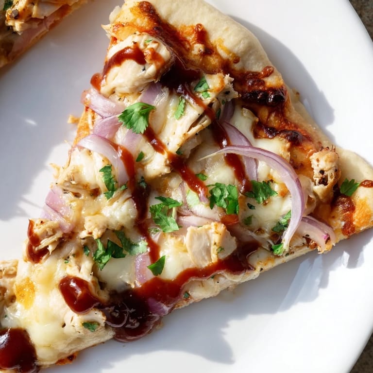 Close-up of a flavorful Chicken BBQ Pizza, showcasing the grilled chicken and golden, crispy crust.
