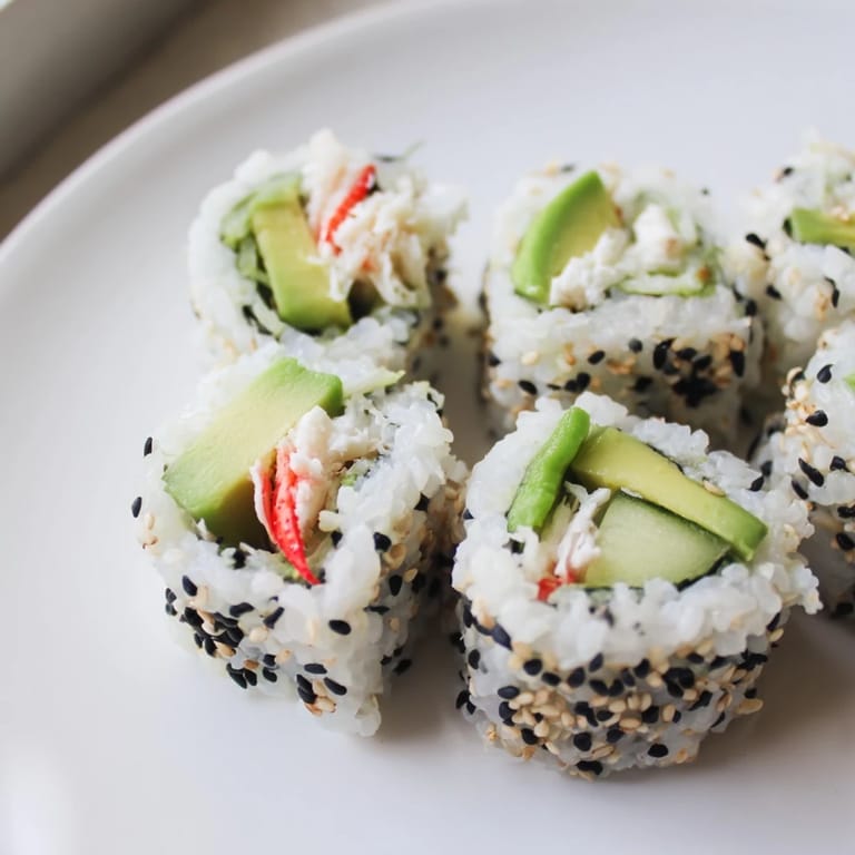 Close-up of a perfectly formed California roll, highlighting the delicious textures and flavors.