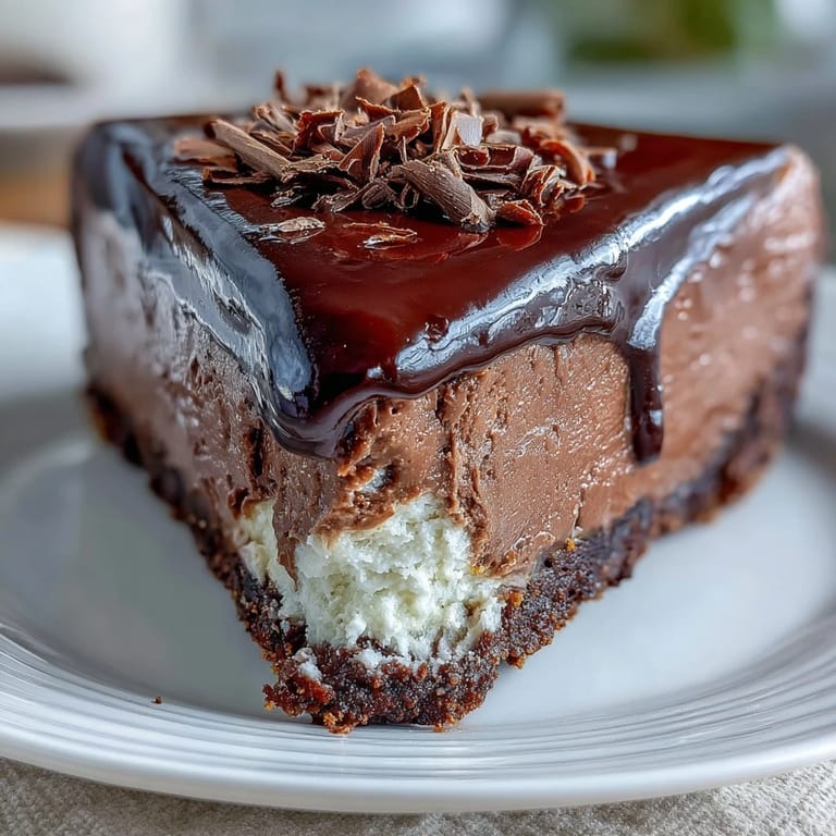 Decadent chocolate cottage cheese cheesecake with a crumbly graham crust, served as a guilt-free high-protein dessert.