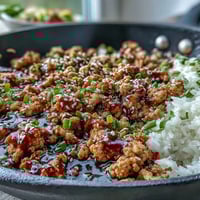 Korean-Style Ground Turkey sizzles in a skillet with a glossy, spicy-sweet sauce, ready to serve over steamed rice.